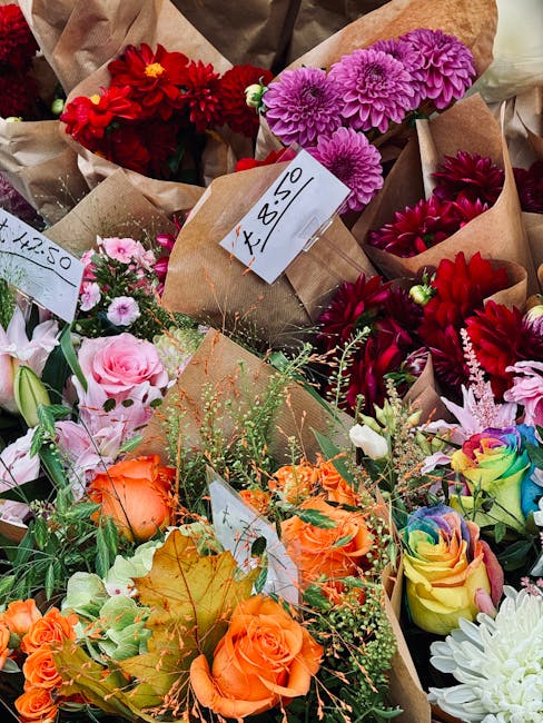 A vibrant assortment of floral bouquets displayed for flower delivery at templeflorist.co.uk, featuring a variety of colourful blooms including red dahlia and pink chrysanthemums arranged in brown kra